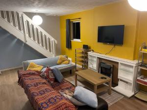 a living room with a couch and a fireplace at Family home near the beach in Saint Annes on the Sea