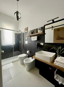 a bathroom with a sink and a toilet and a shower at Onde Dell' Etna 10 in Riposto +59 photos