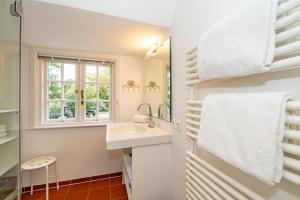 a bathroom with a sink and a window at App Anne in Westerland (Sylt) +12 photos