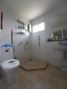 a white bathroom with a toilet and a sink at Spacious Entire House with shared Fitness Room and Shared Indoor Pool in club in Pathum Thani +11 photos
