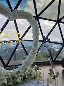 a heart made out of white flowers in front of a window at Bubble Sky Villas Kosove in Ferizaj