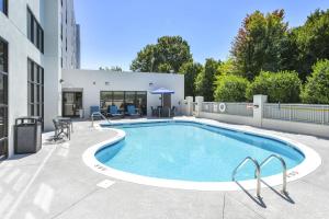 a swimming pool on a patio next to a building at Hampton Inn & Suites Burlington in Burlington