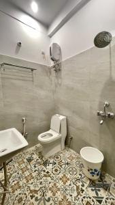 a bathroom with a toilet and a sink at Namastay Kashi in Varanasi +27 photos