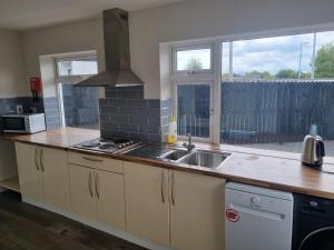 a kitchen with a sink and a counter top at Moorefield Villa Newbridge in Newbridge