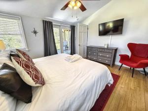 a bedroom with a large bed and a red chair at 826 Wilson Road in Highlands