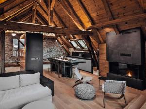 a living room with a couch and a fireplace at Duplex moderne au Casset pour 8 pers avec cheminée et balcon - FR-1-808-10 in Le Monêtier-les-Bains