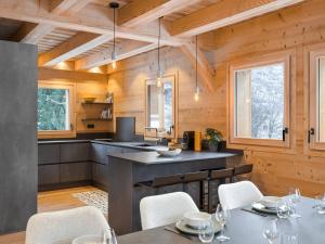 a kitchen and dining room with wooden walls at Chalet neuf 10 pers, charme et confort à Serre Chevalier - FR-1-808-20 in Le Monêtier-les-Bains