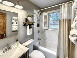 a bathroom with a tub and a toilet and a sink at Highlands Hideout in Highlands +53 photos