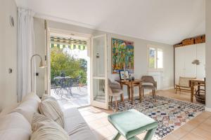 a living room with a white couch and a table at Villa Apartments - Porto Letizia in Porlezza