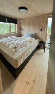 a bedroom with a bed in a room with a window at Architect-Designed Cabin With Views Of Sigdal in Skadeland