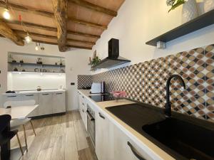 a kitchen with a sink and a counter top at Il Gaudente B&B in Santa Fiora +86 photos