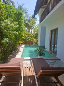 a swimming pool in front of a house at Room witch pool in garden 1 minutes from Ocean in Pingwe