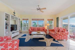 a living room with two couches and a tv at Cape Palms in Port Saint Joe