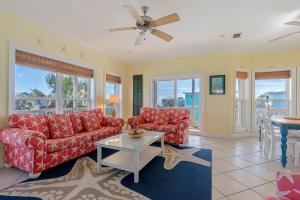 a living room with two red couches and a table at Cape Palms in Port Saint Joe