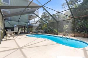 a swimming pool in a house with a glass wall at Cape Palms in Port Saint Joe