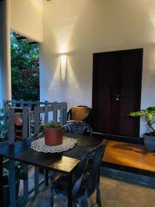 a table and chairs with a potted plant on it at Vibe green villa in Unawatuna