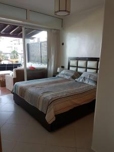 a bedroom with a large bed in a room at Cabobeach Appartement in Cabo Negro +25 photos