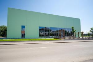 a large glass building on the side of a street at Sport Hotel Ljubljana in Ljubljana