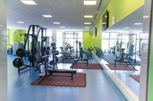 a gym with rows of treadmills and machines at Sport Hotel Ljubljana in Ljubljana