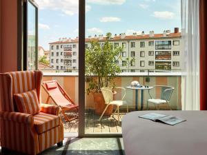 a room with a view of a balcony with a table and chairs at Mama Shelter Lyon in Lyon