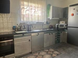 a kitchen with stainless steel appliances and a window at Villa Lyra in Trogir