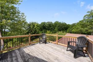 two chairs sitting on the deck of a house at 70 Private Acres-Sleeps 12-Fire Pit-Pet Friendly in Conway