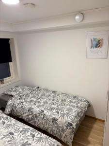 a bedroom with a bed with a comforter at Cozy Aurora View Apartments - Entire 3-Bedroom Fully Furnished Near City Centre in Tromsø