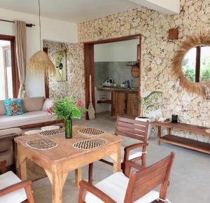 a living room with a wooden table and chairs at Room witch pool in garden 1 minutes from Ocean in Pingwe