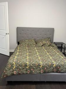a bedroom with a bed with a floral bedspread at One Bet room for 2Bet in Whitby