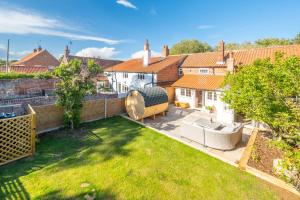 an aerial view of a backyard of a house at Waterhen Cottage in Docking