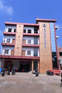 a building with motorcycles parked in front of it at Hotel Neelkanth Palace in Naimishāranya
