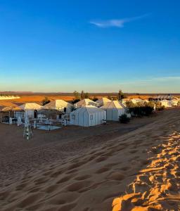 a group of tents on a sandy beach at Oriontal Desert Camp in Merzouga