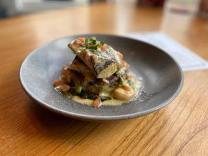 a plate of food on a wooden table at The White Horse in Shipston on Stour