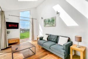 a living room with a couch and a table at Lovely 2 Bedroom Holiday Chalet near Sidmouth in Sidmouth +28 photos