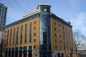 a building with a sign on the top of it at Holiday Inn Express London Stratford by IHG in London