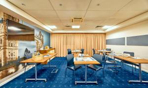 a conference room with wooden tables and chairs at Holiday Inn Express London Stratford by IHG in London