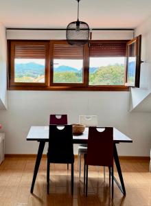 a dining room with a table and three chairs at Aldea Bricia 6 in Posada de Llanes