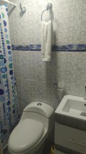 a bathroom with a white toilet and a sink at mini loft apart studio Salento in Salento