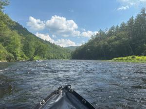a person in a kayak on a river at Riverbend berkshire east basecamp in Charlemont