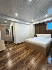 a bedroom with a bed and a projection screen at Pineview Escapes in Jālāpahār +16 photos