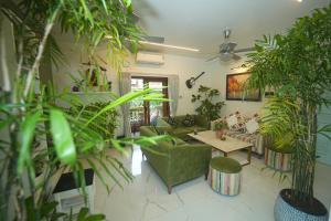 a living room filled with lots of plants at GGH - Ocean Nest, Goa in Candolim