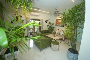 a living room filled with lots of potted plants at GGH - Ocean Nest, Goa in Candolim