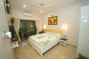 a bedroom with a bed and a ceiling fan at GGH - Ocean Nest, Goa in Candolim +128 photos