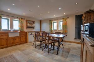 a kitchen with a dining room table and chairs at Finest Retreats - Rough Close Farm Cottage in Ashover
