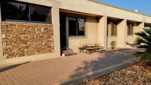 a patio with a table and a building at Stay at 64 Omeya in Windhoek