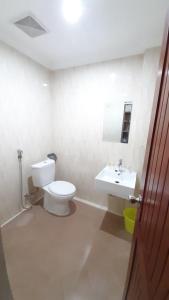 a bathroom with a toilet and a sink at Hotel Prasasti Pacitan in Pacitan +10 photos