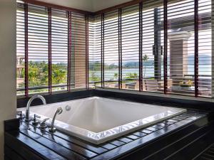 a large bath tub in a room with windows at Pullman Phuket Panwa Beach Resort in Panwa Beach +69 photos