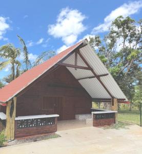a large brown building with a red roof at CHALET - SCEA 2222 Site Agrotouristique in Sinnamary