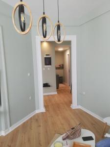 a living room with white walls and wooden floors at Xylokastro Central Apartment in Xylokastron