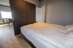 a bedroom with a large white bed in a room at LL Properties TB24 Nest in the North in Akureyri